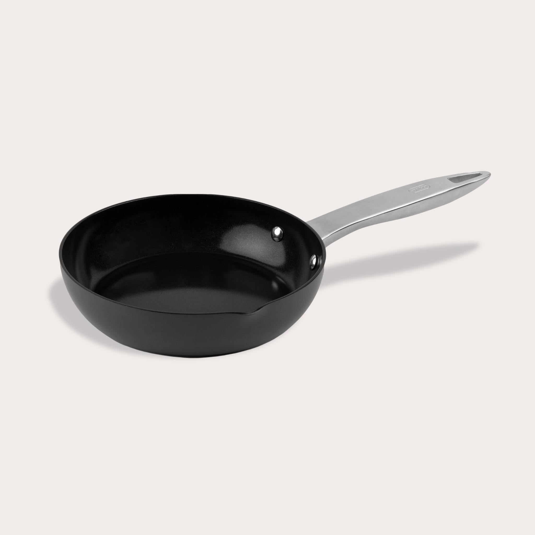 The Zyliss Ultimate Pro Ceramic Fry Pan, featuring a black non-stick coating and a silver metal handle, is displayed against a plain light background. #20cm/8"
