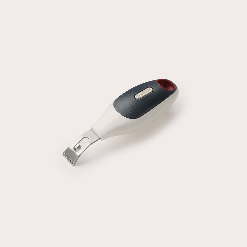 The Zyliss 2 In 1 Zester features a stainless steel peeler and zester with a black and white ergonomic handle plus a red accent, displayed on a plain white background—ideal for effortless citrus prep.