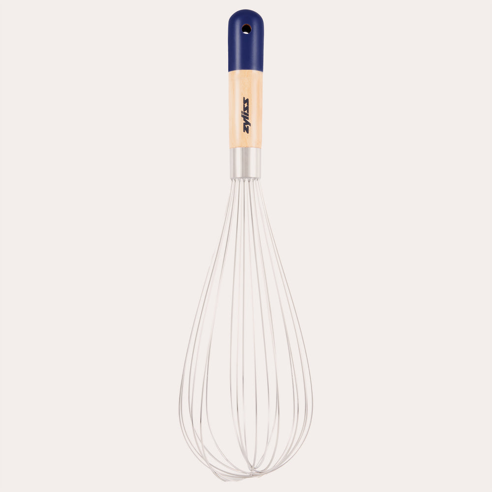 The Zyliss Beech Wood Balloon Whisk has stainless steel wires, a beech wood handle with a blue tip, small hanging hole, and printed logo. Shown on a plain white background.