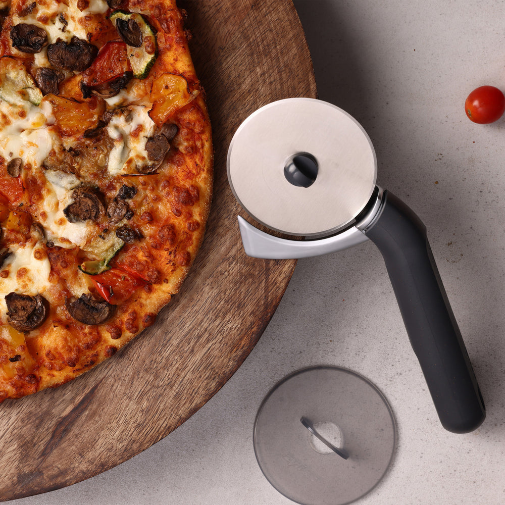 The Zyliss Pizza & Pastry Cutter features a round metal blade and an ergonomic handle, shown against a plain white background.