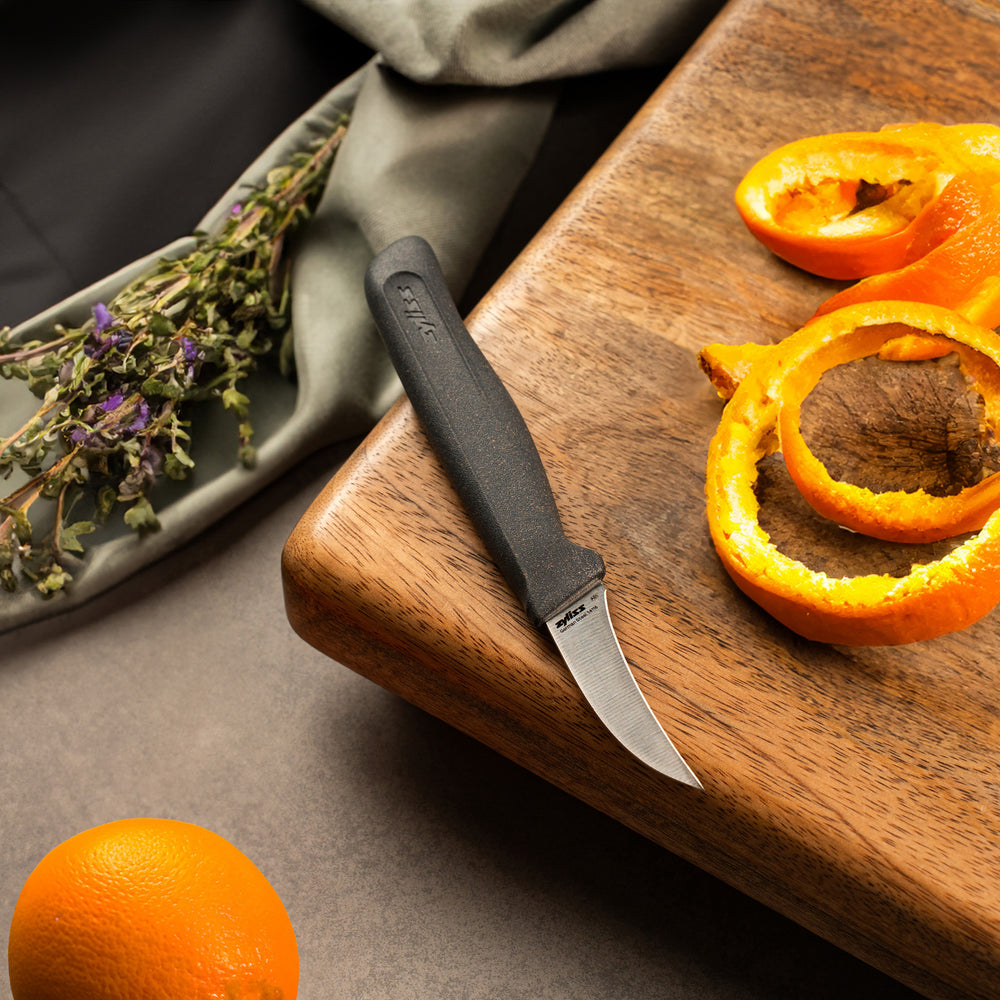 The Zyliss Peeling Knife 6cm / 2½" features an eco-friendly curved blade and ergonomic black handle, shown on a light background. A corner label displays: 4 for 3 mix & match.