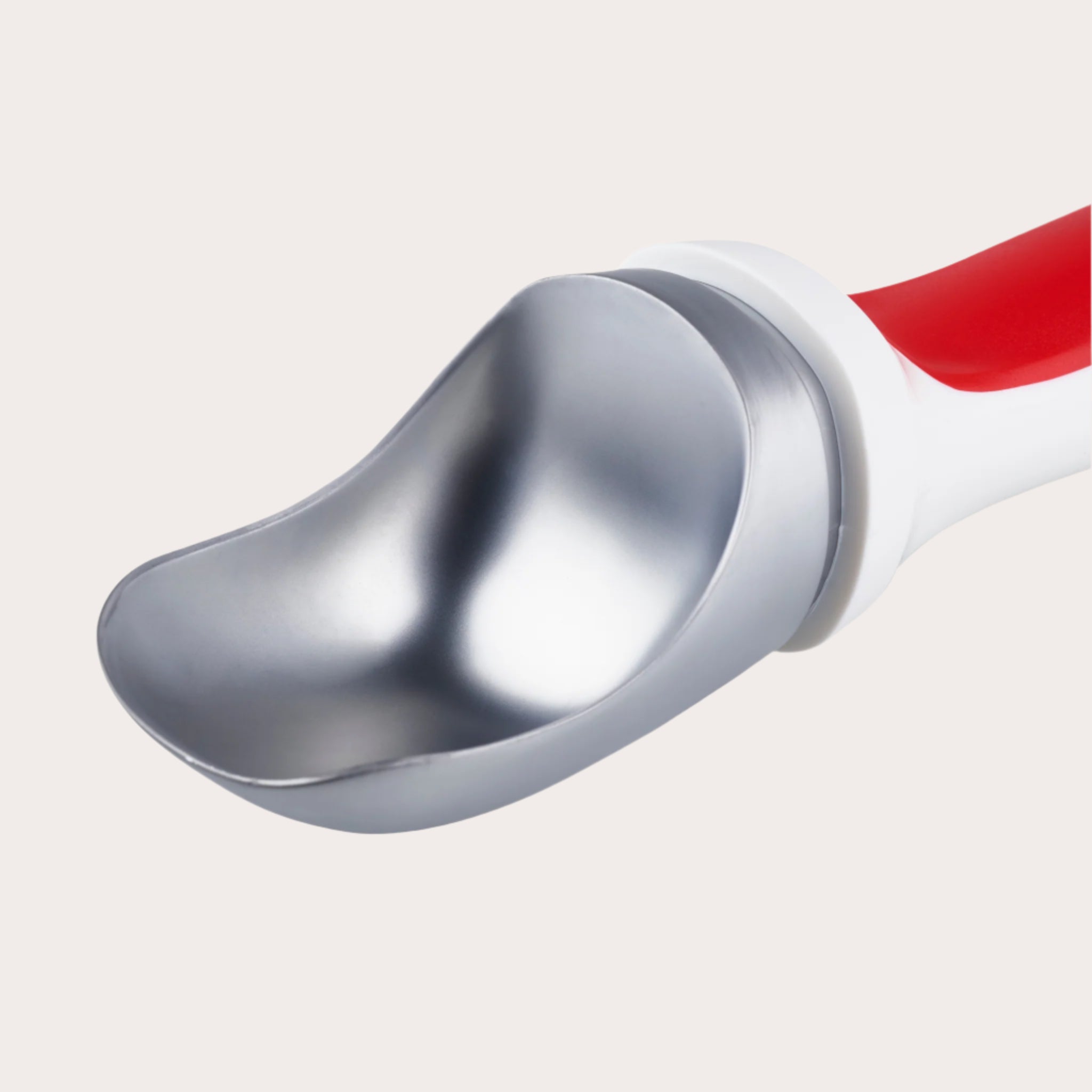 Close-up of the Zyliss Right Scoop Ice Cream Scoop, showcasing its shiny zinc alloy head and red and white ergonomic handle. The wide, slightly curved shape is ideal for easy scooping, isolated on a white background.
