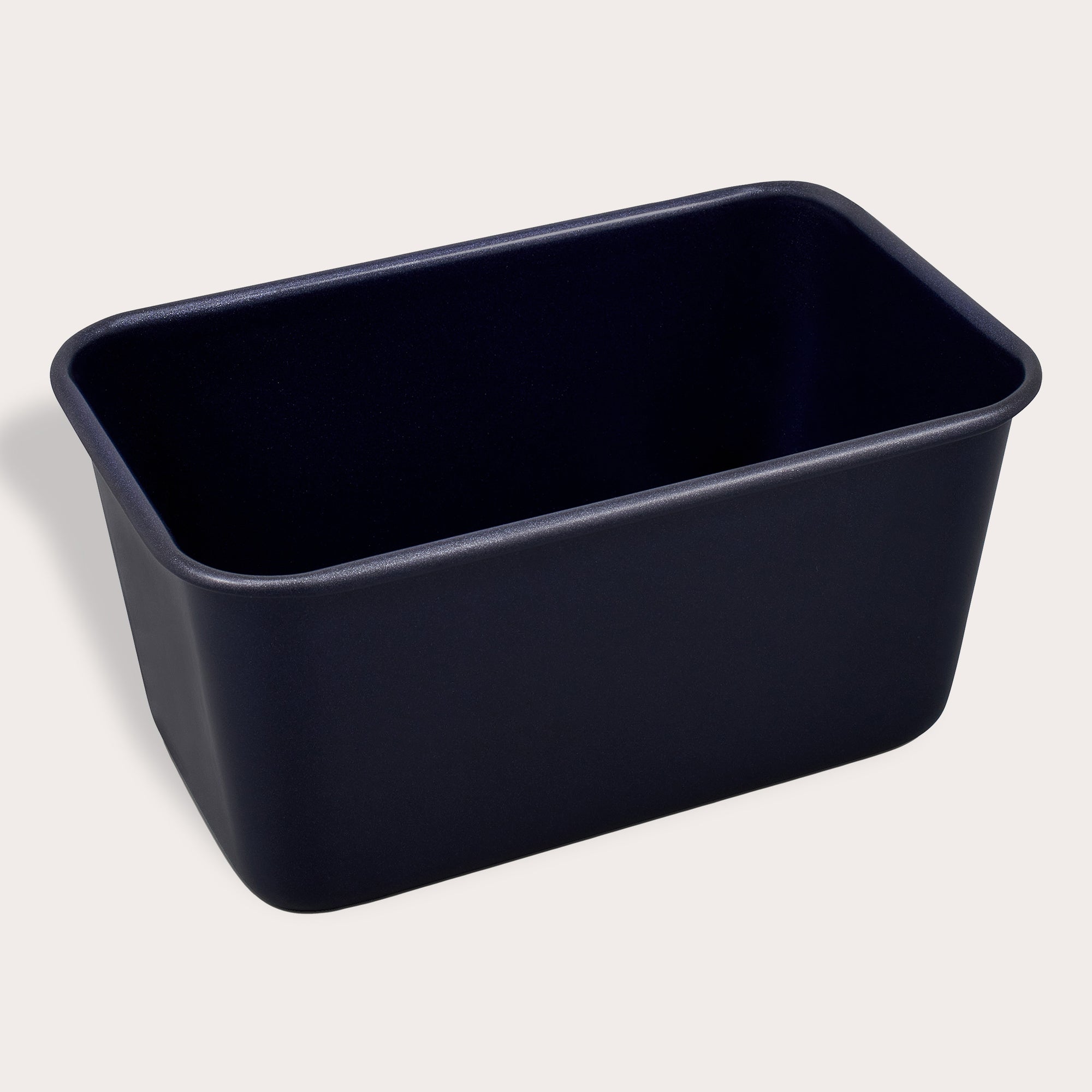 A black rectangular loaf pan with rounded corners, viewed from a slight angle against a plain light background.