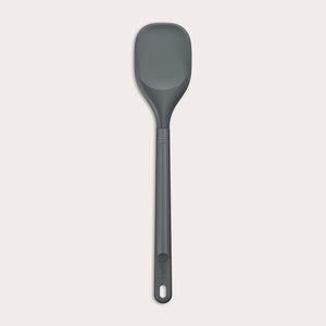 #large A Zyliss Spoontula with a dark gray, rounded silicone head and a long ergonomic handle, featuring a small hanging hole near the end, is displayed against a light background. #Large