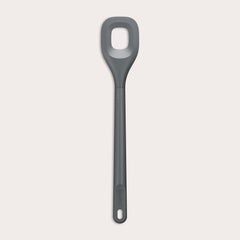 The Zyliss Square Mixing Spoon is a gray, heat-resistant silicone utensil with a long handle and a rectangular hole in the head. Shown on a plain light background, its dishwasher safe for easy cleaning.