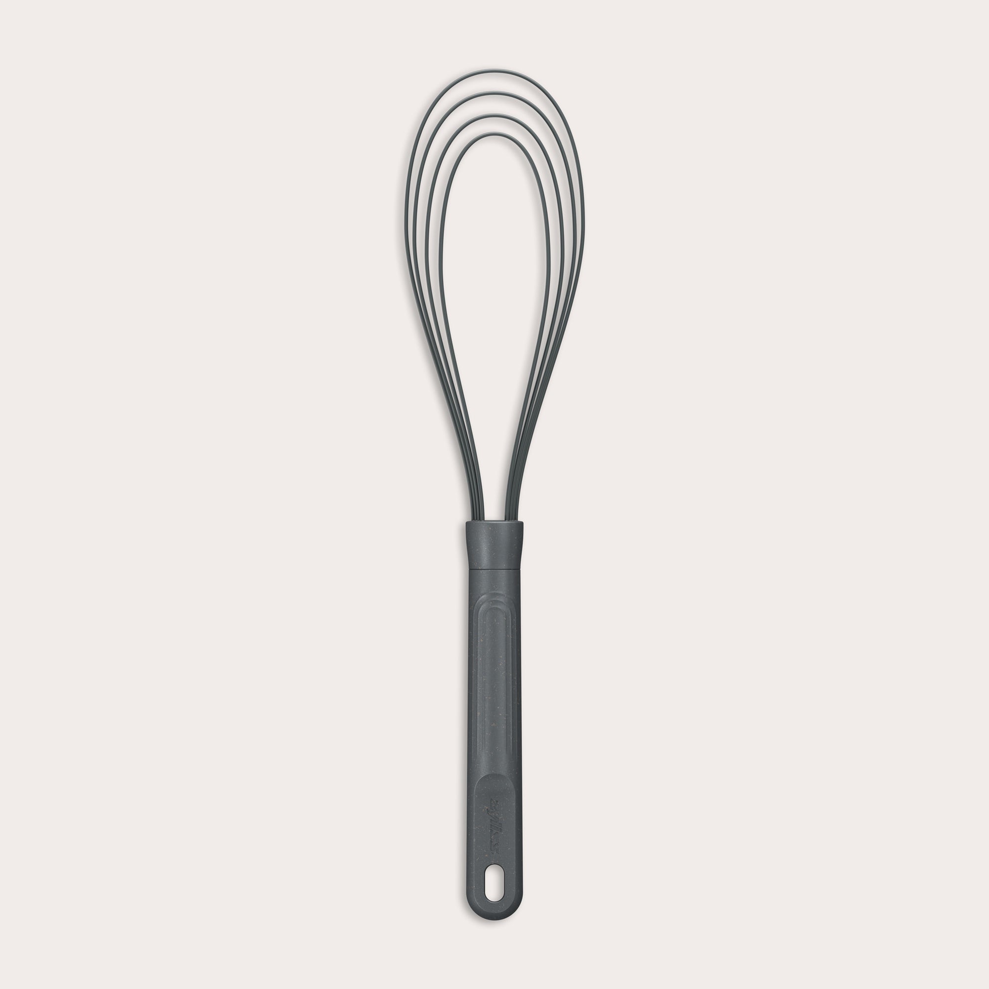 The Zyliss Flat Whisk Silicone features a black, heat-resistant silicone design with a long handle and looped wires, displayed on a plain light background.