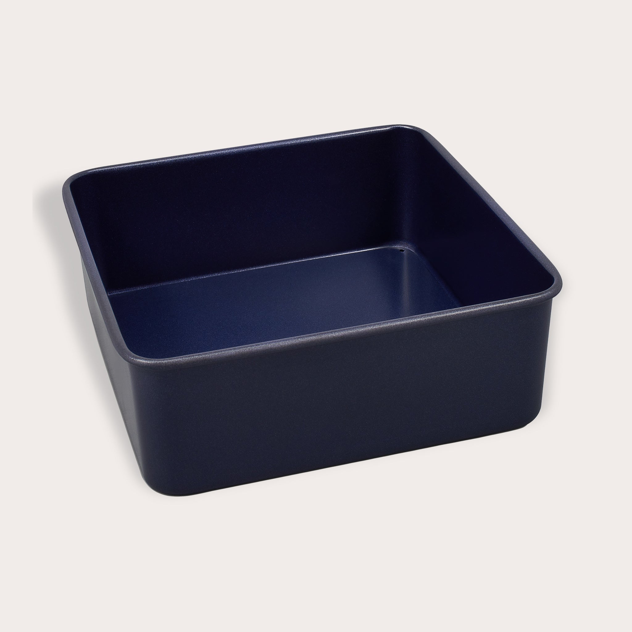 A Zyliss Durable Non-Stick Removable Base Square Pan in navy blue, featuring smooth sides and rounded edges, is shown against a plain light background.