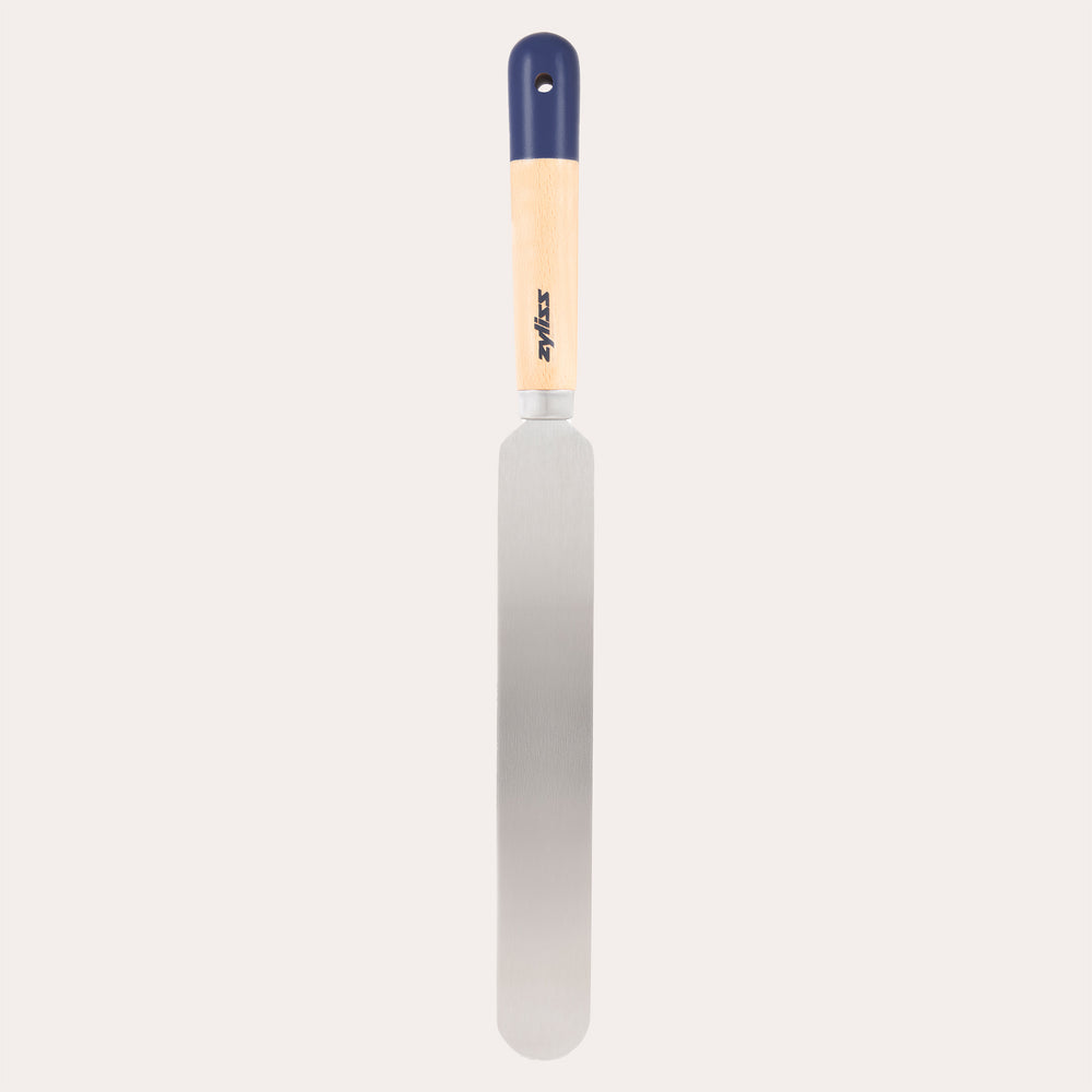 The Zyliss Beech Wood Palette Knife features an ergonomic tan beech wood handle with a dark blue tip and hanging hole, plus a long, flat stainless steel blade—ideal for spreading icing or frosting on cakes.