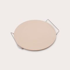 The Zyliss Ceramic Baking Stone, round and beige with a smooth surface, sits on a handled metal rack. This quality accessory is perfect for baking homemade pizza and ensures delicious results every time.