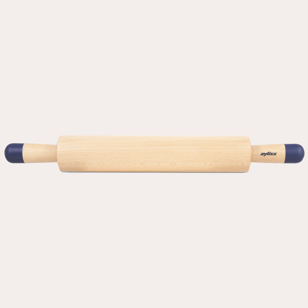 A Zyliss Beech Wood Rolling Pin with blue comfort-grip handles rests horizontally on a light background, showcasing the brand name for an essential tool in any kitchen.