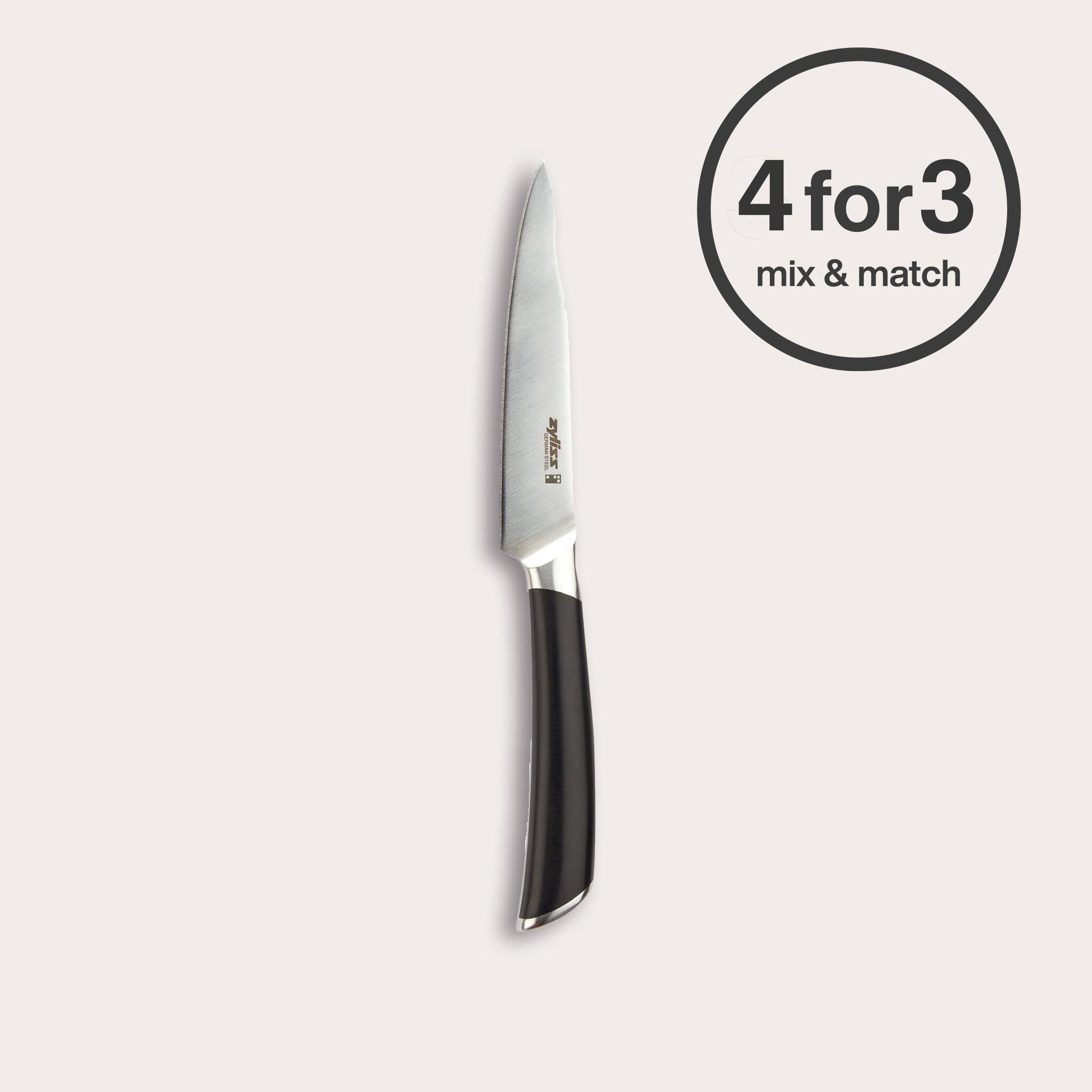 The Zyliss Comfort Pro Paring Knife 11cm/4½" with an ice-hardened blade and black ergonomic handle stands vertically on a white background. A circular label at the top right reads "4 for 3 mix & match.