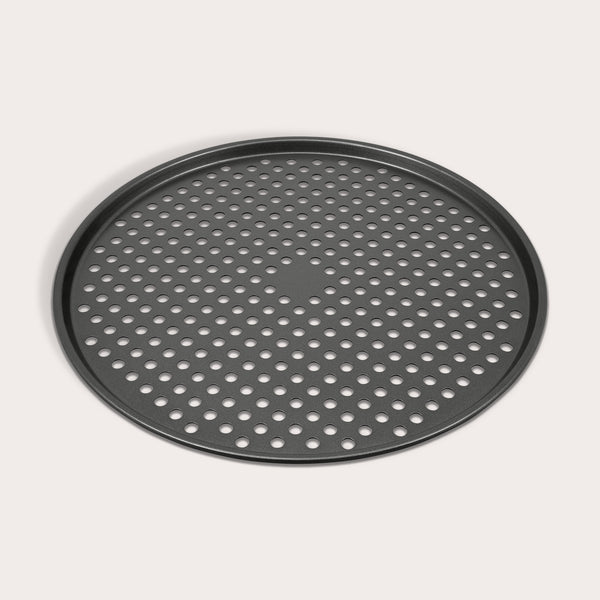 The Zyliss Non-Stick Pizza Tray is a round, black, carbon steel tray featuring numerous evenly spaced holes for crispy pizza bases. Shown on a white background.
