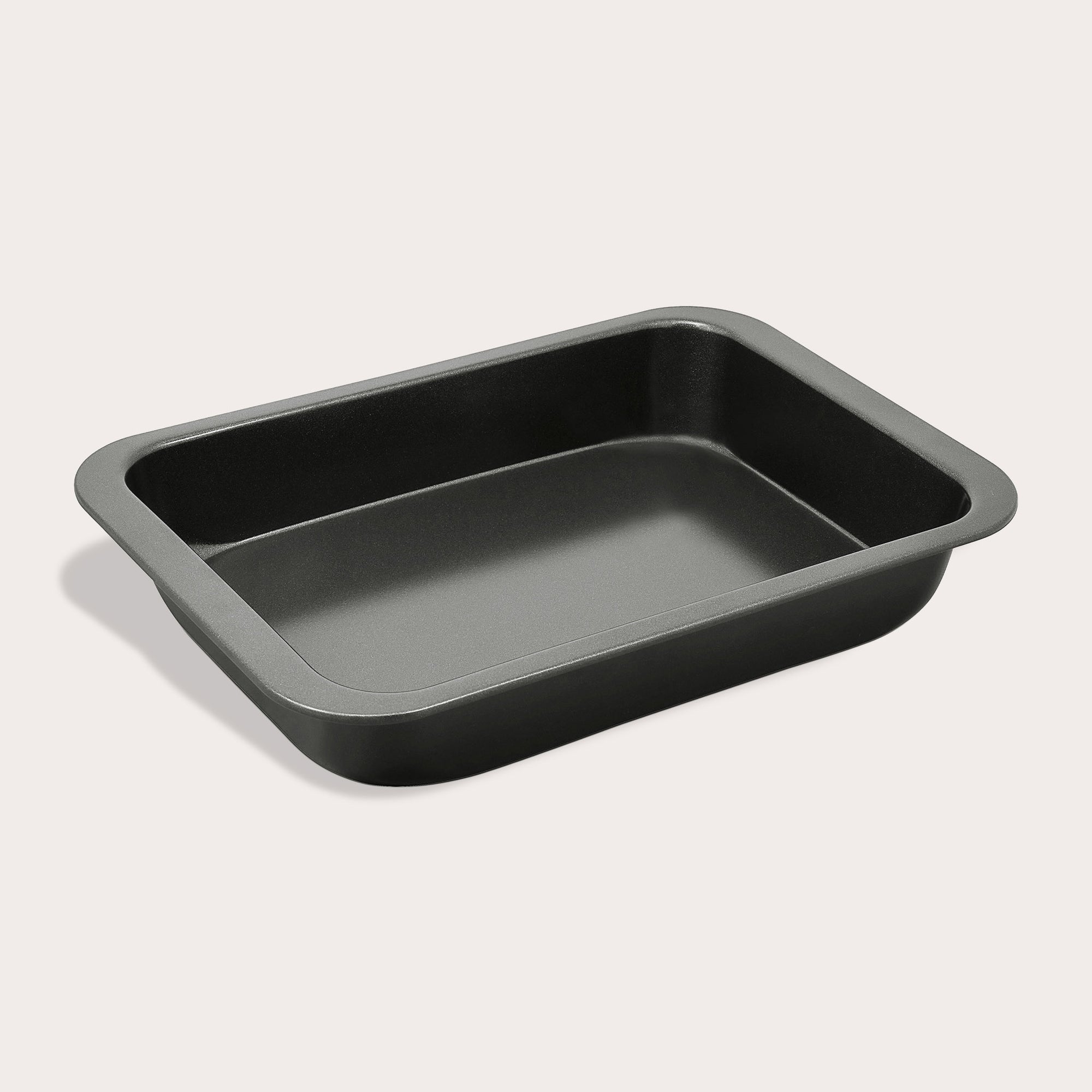 The Zyliss Non-Stick Oven Tray is a rectangular black carbon steel tray with rounded corners, shown empty on a light background.