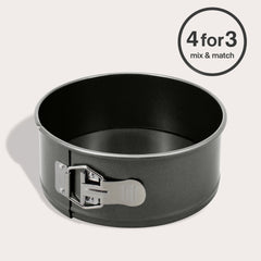The Zyliss Non-Stick Springform Cake Pan, round and black with a silver latch, rests on a light surface. A circular label in the top right corner says "4 for 3 mix & match.