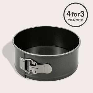 The Zyliss Non-Stick Springform Cake Pan, round and black with a silver latch, rests on a light surface. A circular label in the top right corner says "4 for 3 mix & match.