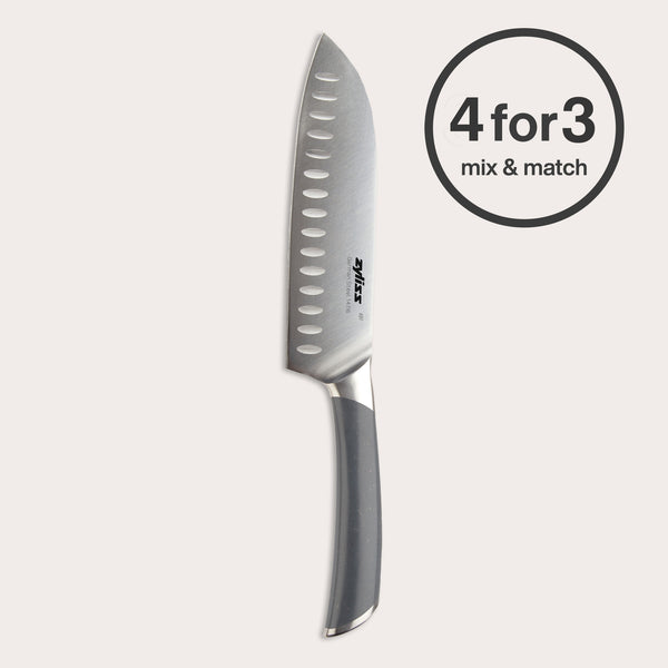 The Zyliss Comfort Pro Santoku Knife 18.5cm/7" with a gray ergonomic handle stands upright on a light background, beside a bold circular label stating "4 for 3 mix & match.