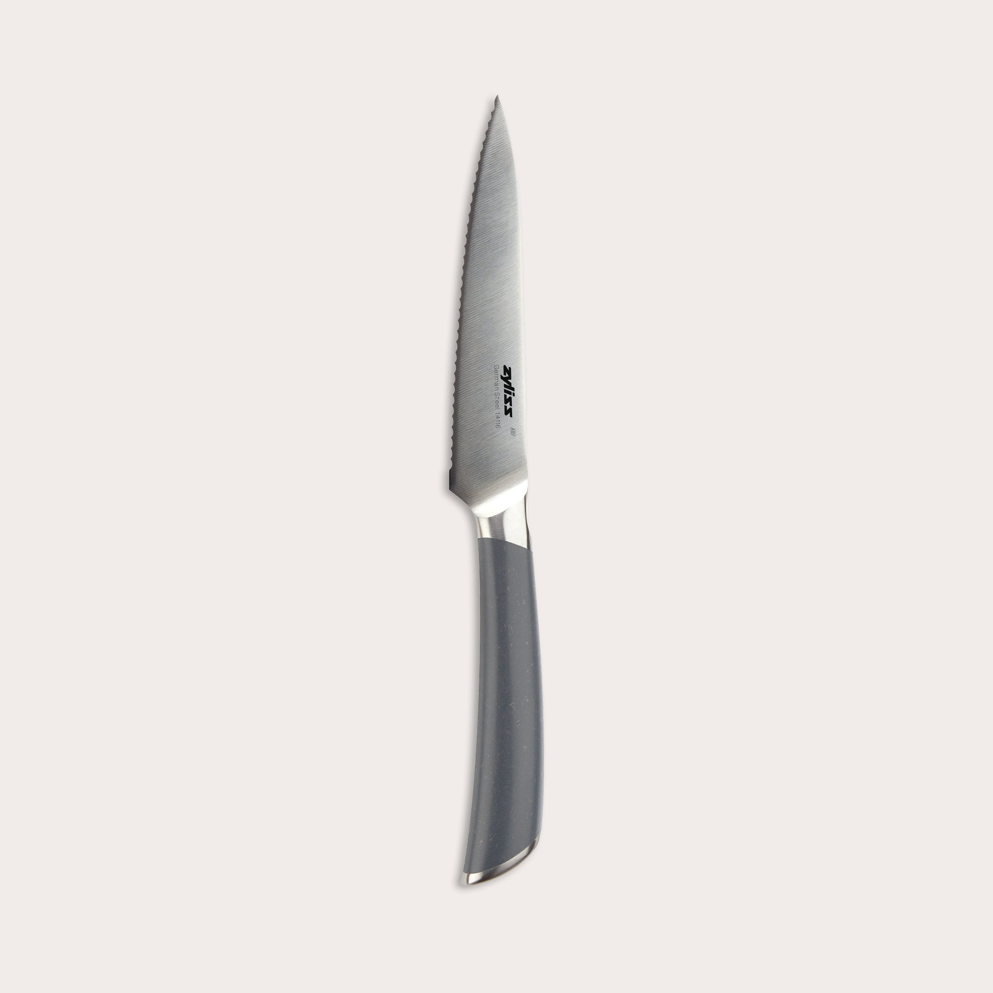 The Zyliss Comfort Pro Serrated Paring Knife 11.5cm features a German stainless steel silver blade and ergonomic gray handle, displayed against a plain light background.