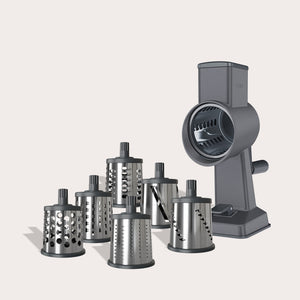 The Zyliss Drum Grater & 6 Drum Accessories is shown, featuring a gray design with a handle and stable base. This versatile kitchen tool includes six interchangeable stainless steel drum blades, providing various hole sizes to suit different grating and slicing needs.