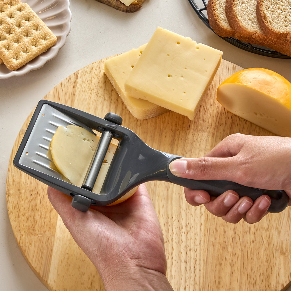 The Zyliss Dial & Slice Cheese Slicer features an adjustable black and silver handle with sharp stainless steel blades for fast slicing, and it's dishwasher safe for easy cleaning.