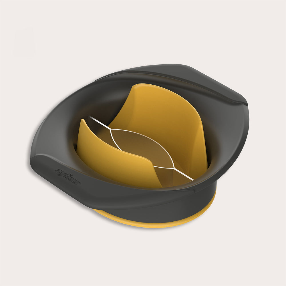 A black and yellow plastic egg separator with a divided interior for separating egg whites from yolks, shown on a light background, designed to complement kitchen gadgets like the Zyliss Mango Splitter.