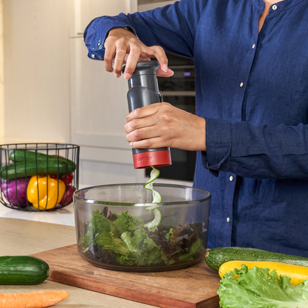 Using the zyliss Spiralizer to make vegetable ribbons over a salad bowl