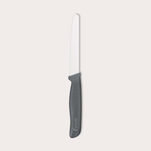 The Zyliss Tomato Knife Serrated 11cm/4½" features a serrated white blade and a black eco-friendly plastic handle, shown against a plain light background—ideal for slicing tomatoes.