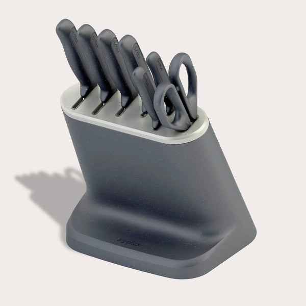 The Zyliss 8-Piece Knife Block features six Japanese stainless steel knives and kitchen scissors with matching dark gray handles in a modern block, shown on a light background.