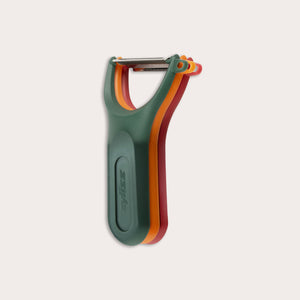The Zyliss 3 Piece Y Peeler Set features ergonomic handles and Swiss-made stainless steel blades in green, orange, and red, stacked vertically against a plain light background.