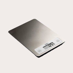 The Zyliss Digital Food Scale features a stainless steel surface, precision weighing, and displays 125 grams. It has unit and tare buttons next to the display for easy use.