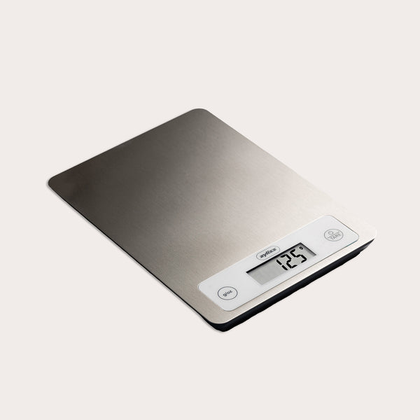 The Zyliss Digital Food Scale features a stainless steel surface, precision weighing, and displays 125 grams. It has unit and tare buttons next to the display for easy use.