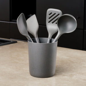 The Zyliss 5-Piece Utensil Set includes four gray kitchen tools—spatula, slotted spatula, ladle, and spoon—in a matching holder. Dishwasher safe and ideal for any modern kitchen. 