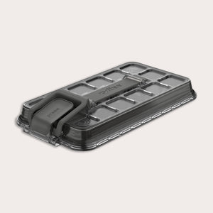 A rectangular, transparent plastic lid for the Zyliss Press & Pull Ice Cube Tray with a gray foldable handle, textured grid pattern, and "Zyliss" embossed on top, shown on a light background.