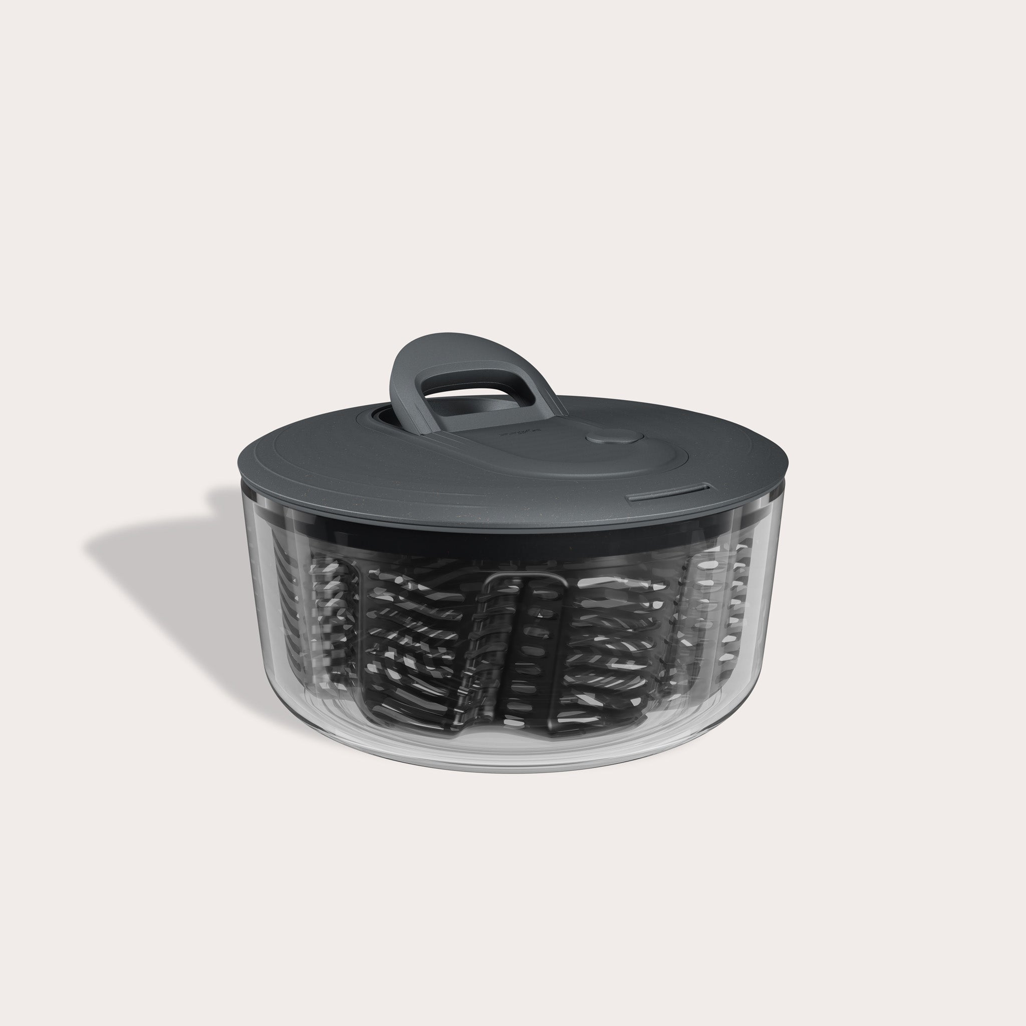 The Zyliss Easy Spin Salad Spinner features a clear plastic bowl, dark gray lid and handle, AquaVent technology, and a visible inner basket—making it a smart pick for any eco-friendly kitchen.