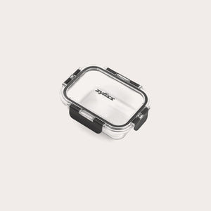 A small, clear rectangular Zyliss Glass Container with a black latch on the front and sides ensures a secure seal. The lid is printed with Zyliss. Shown empty against a white background, its perfect for meal prep. #0.37L/0.39qt