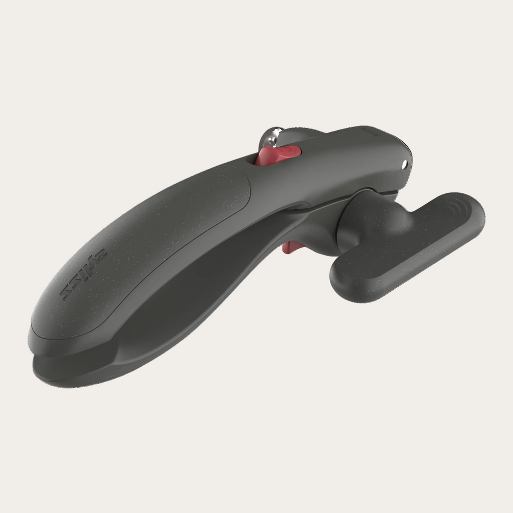 A dark gray ergonomic tool with a textured finish, featuring a small red button and a silver metal ring, shown on a solid white background.
