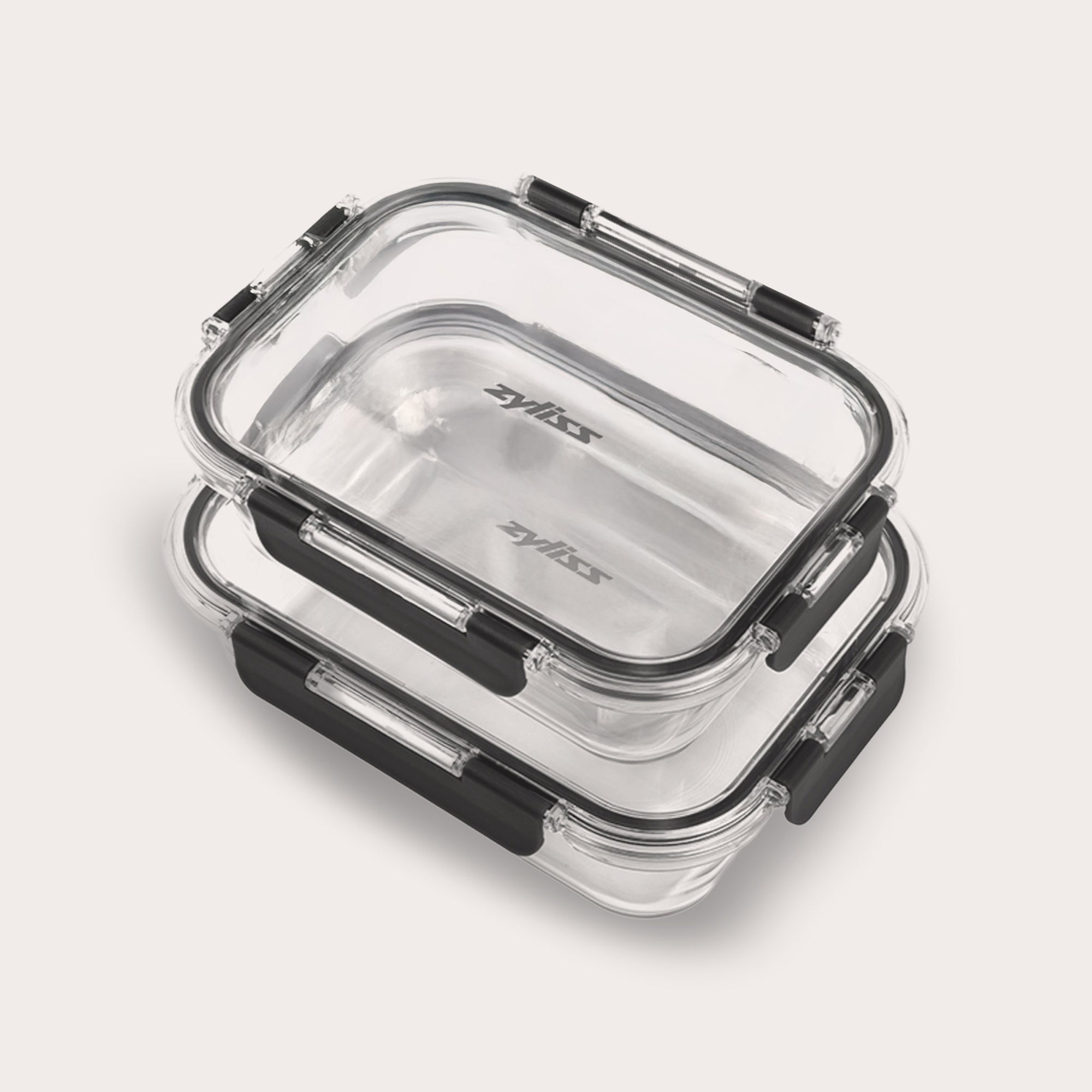 The Zyliss 2-Piece Glass Container Set features two transparent borosilicate containers with black clasps and lids. These airtight, leak-proof containers are stackable and display the Zyliss logo inside.