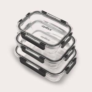 The Zyliss 3-Piece Set Glass Container Set includes clear rectangular borosilicate containers with black locking lids, shown stacked against a light background. They are leak-proof for safe, secure storage.