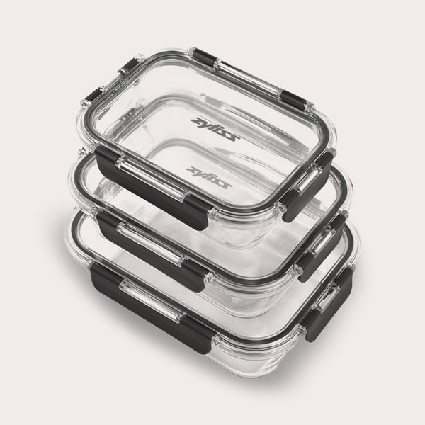 The Zyliss 3-Piece Set Glass Container Set includes clear rectangular borosilicate containers with black locking lids, shown stacked against a light background. They are leak-proof for safe, secure storage.