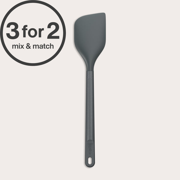 The Zyliss Spatula is a dark gray, heat-resistant silicone tool with a long handle and angled head. A circular 3 for 2, mix & match label appears in the corner. Safe for non-stick cookware and easy to clean, displayed on a plain white background.#Large
