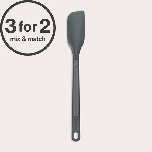 A long-handled Zyliss Spatula in dark gray with a heat-resistant silicone head is displayed on a light background. A 3 for 2 mix & match circular label appears in the top left corner.#Small