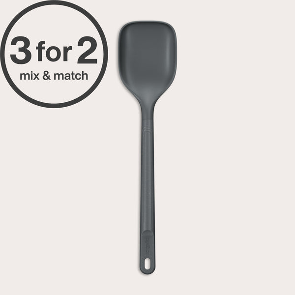 A dark gray, heat-resistant Zyliss Spoon with a hole in the handle is shown vertically against an off-white background. A 3 for 2 mix & match circular label appears in the top left corner.#Large