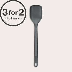 A dark gray Zyliss Spoon with a long handle, heat-resistant and dishwasher safe, stands vertically on a light background. A circular 3 for 2 mix & match offer label appears in the top left corner.#Medium