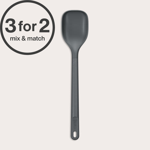 A dark gray Zyliss Spoon with a long handle, heat-resistant and dishwasher safe, stands vertically on a light background. A circular 3 for 2 mix & match offer label appears in the top left corner.#Medium
