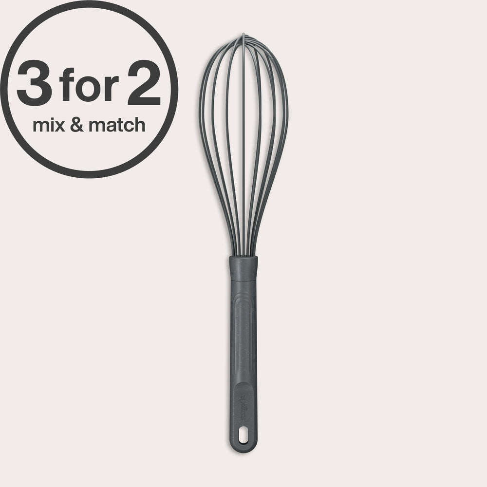 A Zyliss Balloon Whisk Silicone with a black silicone-coated head and gray handle stands upright on a light background. A circular 3 for 2 mix & match label appears in the top left, highlighting its suitability for non-stick cookware.
