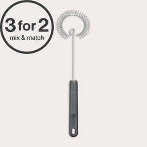 A Zyliss Gravy Whisk with a black handle is displayed upright on a light background. A 3 for 2 mix & match circular graphic appears in the top left corner. Ideal for preparing sauces.