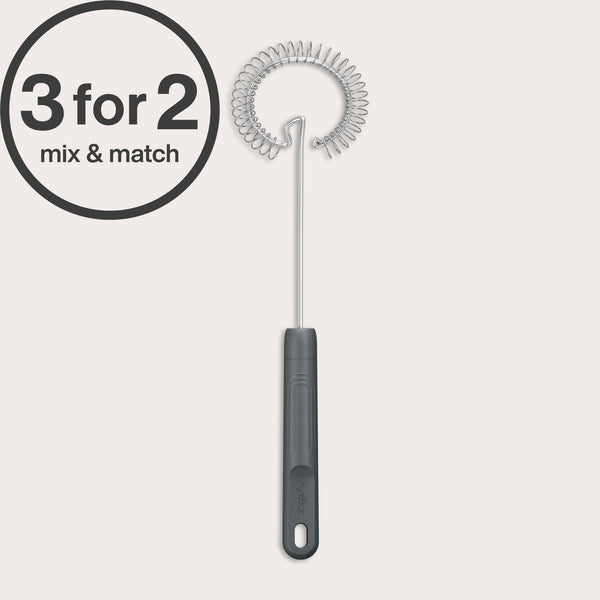 A Zyliss Gravy Whisk with a black handle is displayed upright on a light background. A 3 for 2 mix & match circular graphic appears in the top left corner. Ideal for preparing sauces.