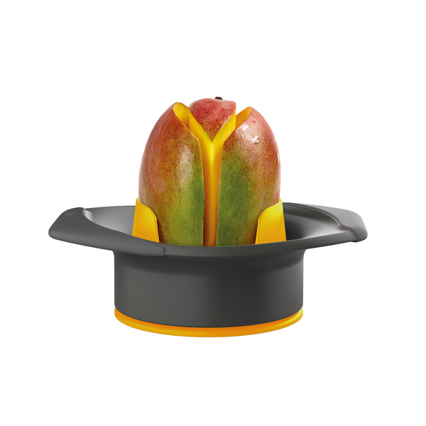 A mango sits upright in the Zyliss Mango Splitter, a black and yellow tool designed to cut the fruit into sections. The splitter features handles on both sides, and the mango is partially sliced but still held together.