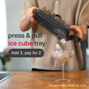 A person uses the Zyliss Press & Pull Ice Cube Tray to add ice to a cocktail glass. Add 3, pay for 2—discount valid until 31.08.2026.