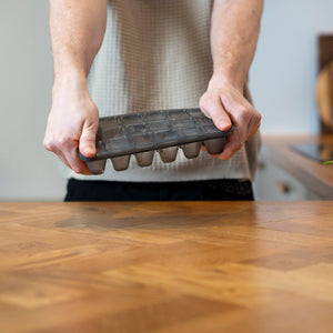 Twisting a zyliss Classic Ice Cube Tray to release the ice cubes.
