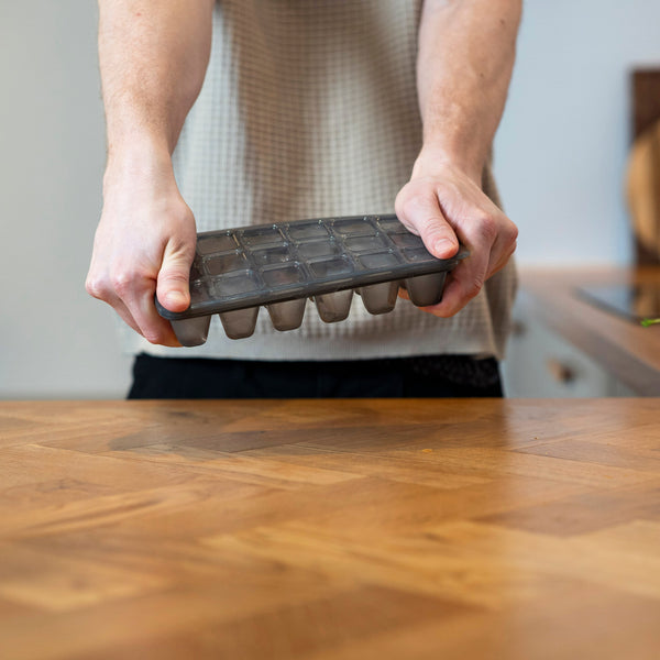 Twisting a zyliss Classic Ice Cube Tray to release the ice cubes.